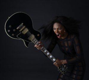 Angry woman smashing guitar
