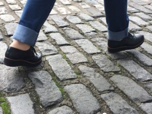 Feet walking on paving stones