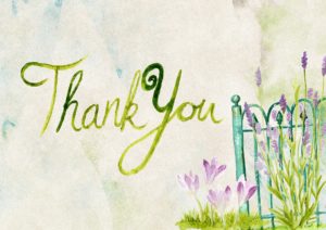 thank you note with green letters and purple flowers peeking through a green metal fence