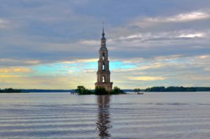 Bell tower on an island in the Volga river, against a dramatic cloud background.